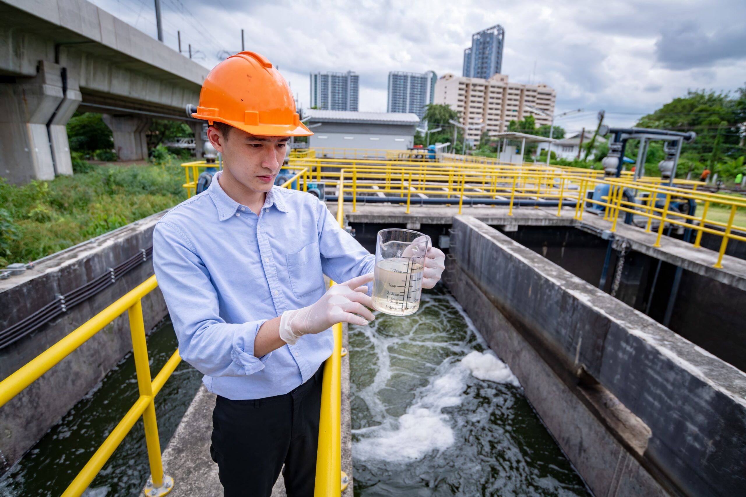 engineer take water from wastewater treatment pond 2023 11 27 04 59 26 utc scaled