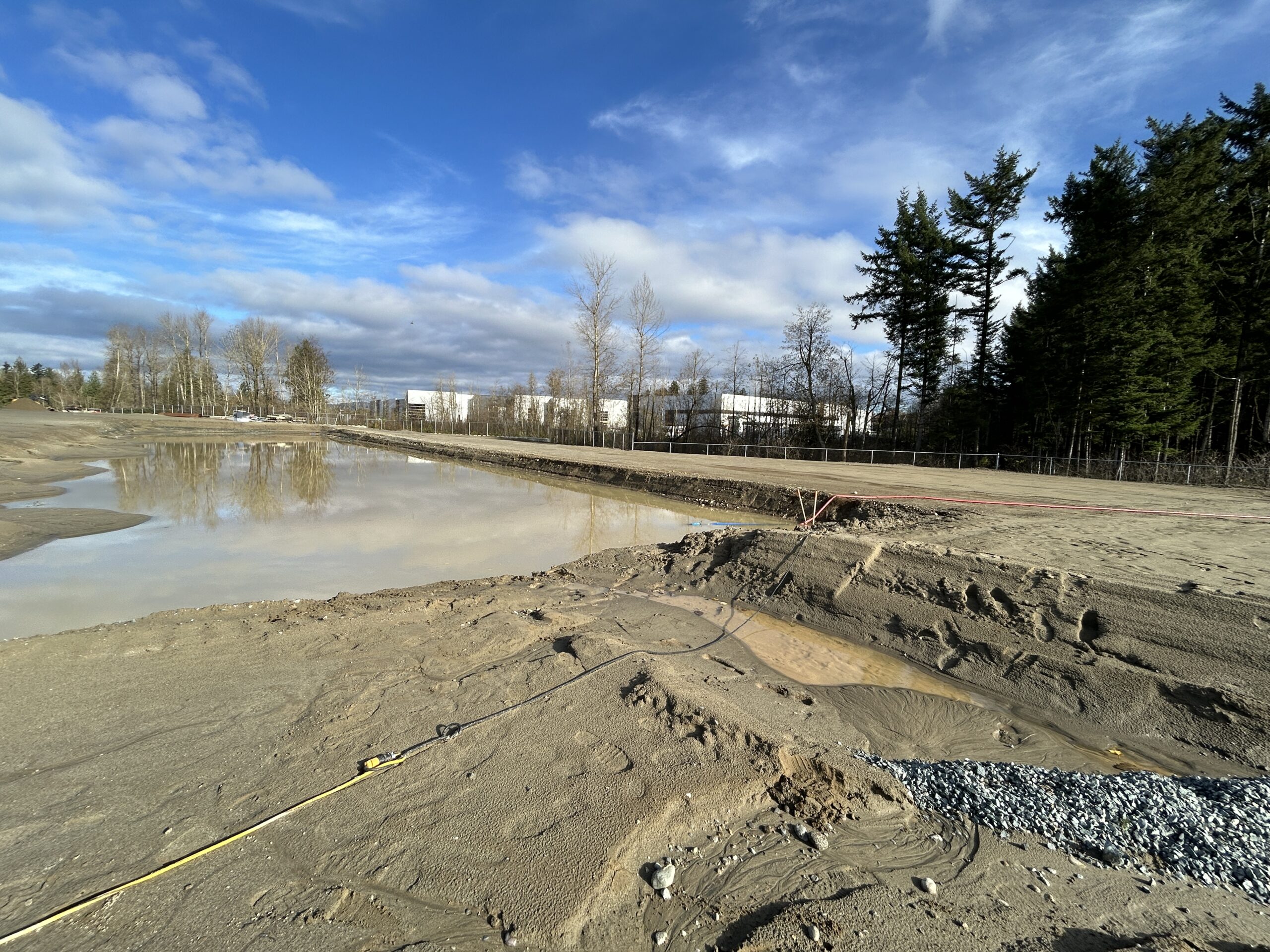 TigerFloc flocculant system clarifying sediment in water at an industrial job site for on-site sediment control